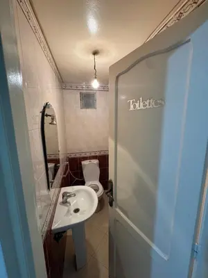 a bathroom with a toilet and a sink at Maison kossay in Casablanca