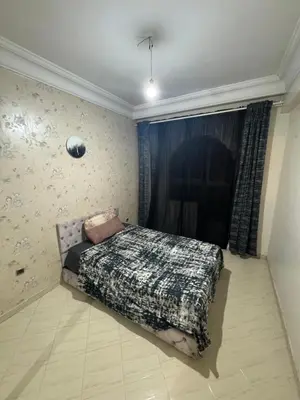 a bedroom with a bed in the corner of a room at Maison kossay in Casablanca