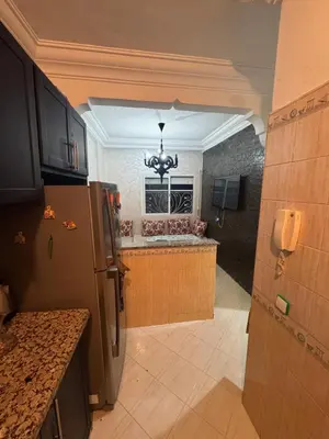 a kitchen with a refrigerator and a counter at Maison kossay in Casablanca