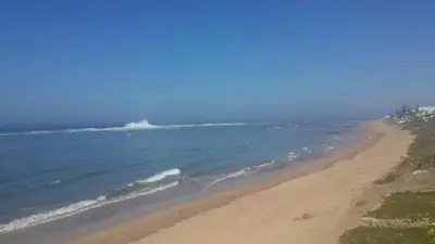 a view of a beach and the ocean at beachfront house frond de mer in Skhirat