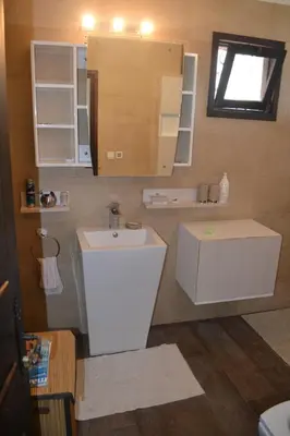 a bathroom with a sink and a mirror at beachfront house frond de mer in Skhirat