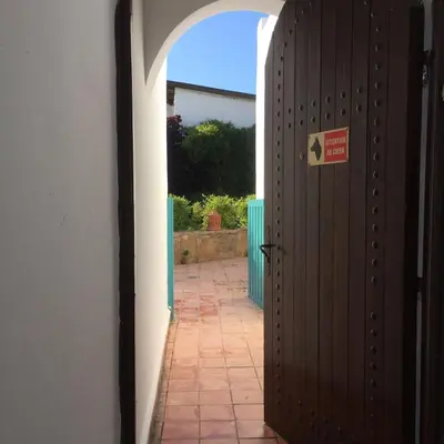 an entrance to a house with a wooden door at beachfront house frond de mer in Skhirat