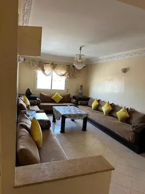 a living room with a couch and a table at Ryad chaouia in Dar Mohammed Ould Haj Jilali