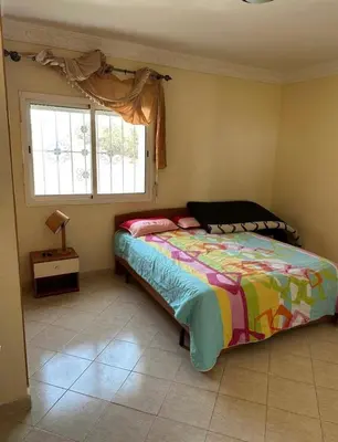 a bedroom with a bed and a window at Ryad chaouia in Dar Mohammed Ould Haj Jilali
