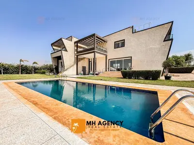 a house with a swimming pool in front of it at Oliveraie - Villa Benslimane in O Ben Slimane
