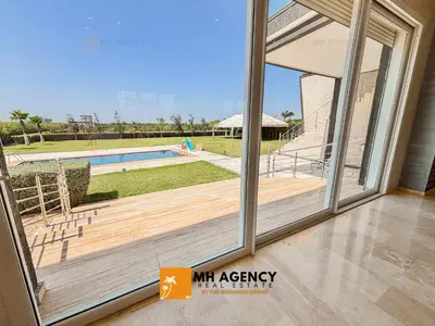 a view of the pool from a house with sliding glass doors at Oliveraie - Villa Benslimane in O Ben Slimane