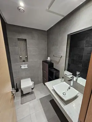 a bathroom with a sink and a toilet and a mirror at Prestigia Luxury and Serenity in Rabat