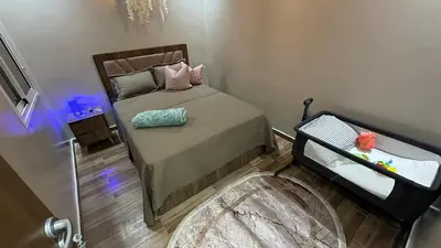 a small bedroom with a bed with a blue light at cozy appartement in Casablanca