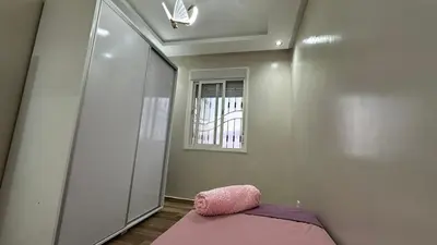 a bedroom with a pink pillow and a mirror at cozy appartement in Casablanca