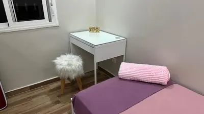 a room with a white table and a purple pillow at cozy appartement in Casablanca