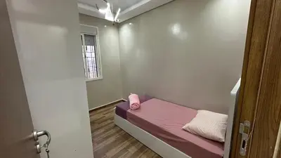 a small room with a bed and a window at cozy appartement in Casablanca