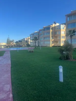 a large grassy field with a building in the background at Evazion in O Ben Slimane