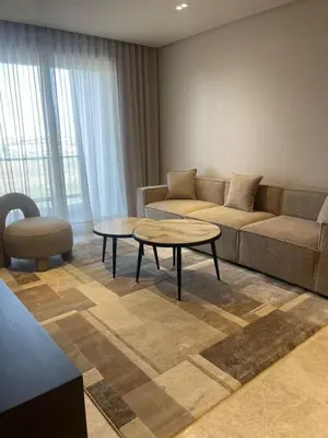 a living room with a couch and a table at Cosy 2 chambres - Clim & Parking in Casablanca