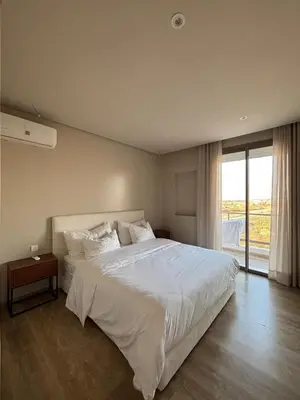 a bedroom with a large white bed and a window at Cosy 2 chambres - Clim & Parking in Casablanca