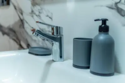 a sink with a soap dispenser and a bottle of soap at maarif Centre elegant et comfortable duplex in Casablanca