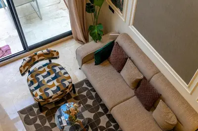 a living room with a couch and a table at maarif Centre elegant et comfortable duplex in Casablanca