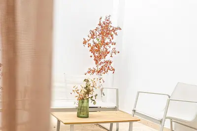 a vase of flowers on a table in a room at maarif Centre elegant et comfortable duplex in Casablanca