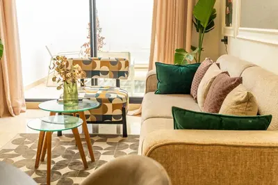 a living room with a couch and a table at maarif Centre elegant et comfortable duplex in Casablanca