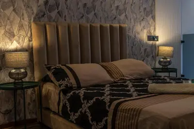 a bedroom with a bed and two tables with lamps at maarif Centre elegant et comfortable duplex in Casablanca