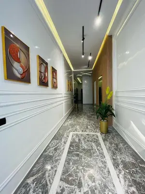a hallway with paintings on the walls and a plant at Studio Élégant et Moderne a Maarif, Casablanca in Casablanca