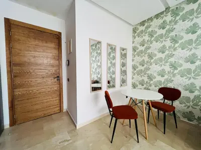 a room with a table and two chairs and a door at Studio Élégant et Moderne a Maarif, Casablanca in Casablanca