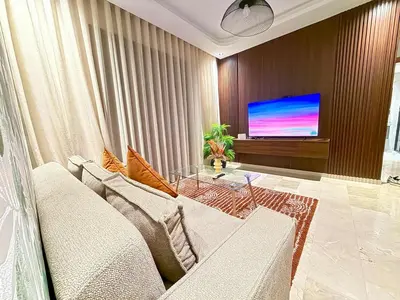a living room with a couch and a flat screen tv at Studio Élégant et Moderne a Maarif, Casablanca in Casablanca