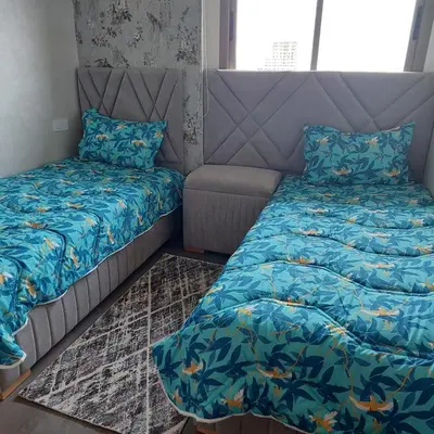 a bedroom with a bed and a couch at appartement à Zenata casablanca in Aïn Harrouda