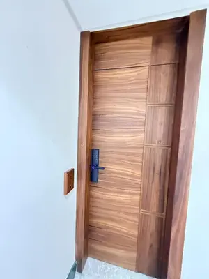 a wooden door in the corner of a room at Luxurious Boho-Styled Duplex - Rooftop Sky Pool in Casablanca