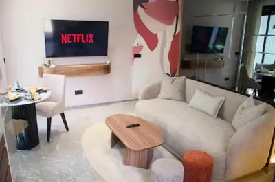 a living room with a couch and a table at Luxurious Boho-Styled Duplex - Rooftop Sky Pool in Casablanca