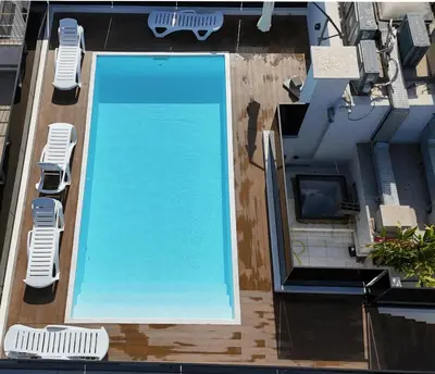an overhead view of a swimming pool with two lounge chairs at Luxurious Boho-Styled Duplex - Rooftop Sky Pool in Casablanca
