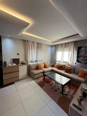 a living room with a couch and a glass table at Modern Cozy Apartment Near beach in Casablanca