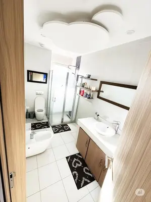 a bathroom with two sinks and a toilet at Modern Cozy Apartment Near beach in Casablanca