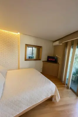 a bedroom with a white bed and a window at Modern Cozy Apartment Near beach in Casablanca