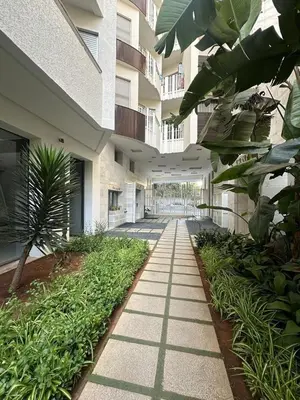 a hallway of a building with plants and a walkway at Modern Cozy Apartment Near beach in Casablanca