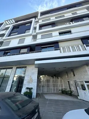 a building with a car parked in front of it at Modern Cozy Apartment Near beach in Casablanca