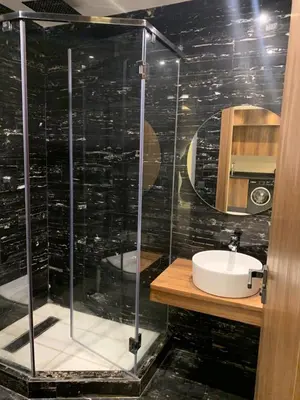 a bathroom with a glass shower and a sink at Chic Studio Near Beach & Cafés in Casablanca