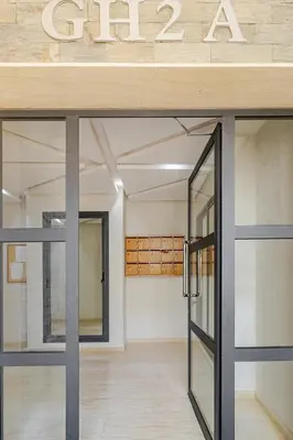 a door in a room with a sign on the wall at Elegant Apartment with Pool & Moroccan Lounge in Bouznika