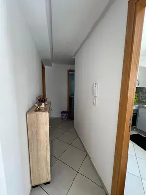 a room with a hallway with a table and a counter at Elegant Apartment with Pool & Moroccan Lounge in Bouznika