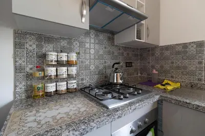 a kitchen with a stove and a counter top at Elegant Apartment with Pool & Moroccan Lounge in Bouznika
