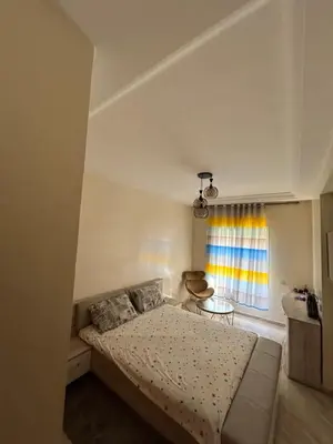 a bedroom with a bed and a window at Ricoflores Palm in O Ben Slimane