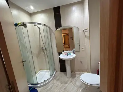 a bathroom with a shower and a toilet and a sink at Ricoflores Palm in O Ben Slimane
