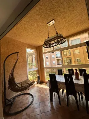 a dining room with a table and a hammock at Ricoflores Palm in O Ben Slimane