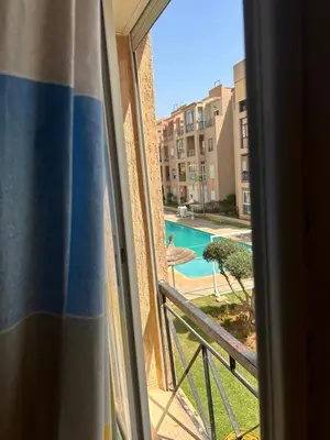 a view of a pool from a window at Ricoflores Palm in O Ben Slimane