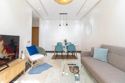 a living room with a couch and a table at Studio 1 Min Beach - Pool - Air conditioning - Fiber in Mohammedia