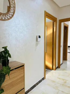 a hallway with a door and a phone on a wall at Studio 1 Min Beach - Pool - Air conditioning - Fiber in Mohammedia