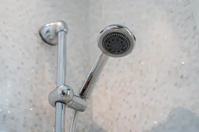 a shower with a shower head in a bathroom at Elegant Family Unit with Pool & Gym Casa Finance City m2a in Casablanca