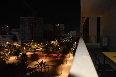 a view of a city at night from a balcony at Kridarek - Appartement chic et cosy à Casa Finance City in Casablanca