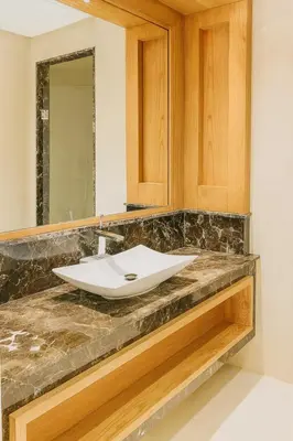 a bathroom counter with a sink and a mirror at Kridarek - Appartement chic et cosy à Casa Finance City in Casablanca