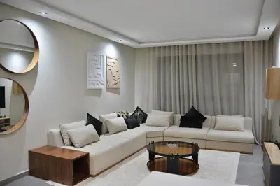 a living room with a white couch and a table at Lux apartment, wifi, Netflix, parking in Casablanca