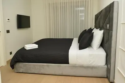 a bedroom with a large bed with black and white pillows at Lux apartment, wifi, Netflix, parking in Casablanca